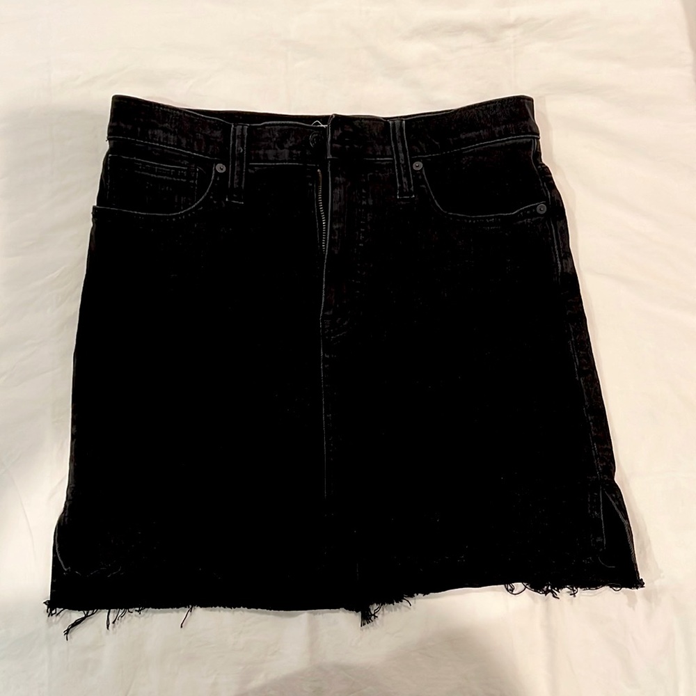 Madewell black denim skirt. Frayed hem that is shorter in front than in back.